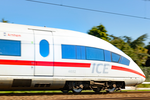 Approaching German highspeed ICE train on the Amsterdam-Cologne line. The Intercity-Express, InterCityExpress or ICE is a system of high-speed trains running in Germany and its surrounding countries. This specific train is an ICE of the third generation, its maximum speed is around 320km/h and runs for both the Dutch Railways (NS) and the Deutsche Bahn (DB).