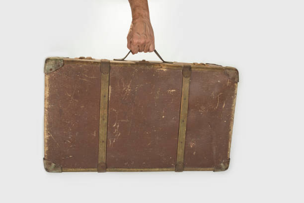 istock Old brown retro suitcase on a white background 1259924750