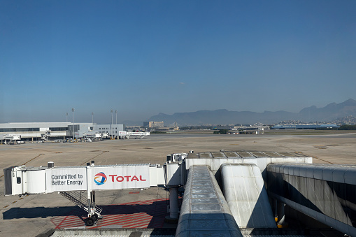Corridor without leading to an airplane on practically empty international airport of Rio de Janeiro during COVID-19 coronavirus outbreak city in the background