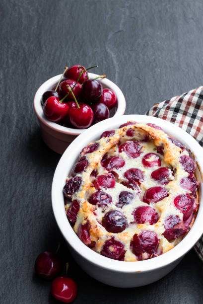istock Clafouti cherry pie on black stone background 1259929085