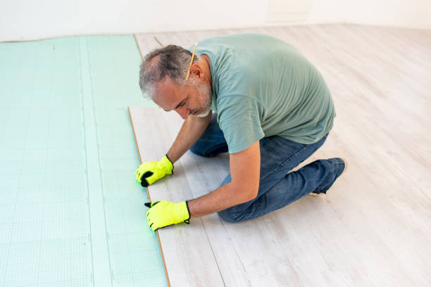 istock Mature Man Positioning Laminate Floor Accuratly 1259934179