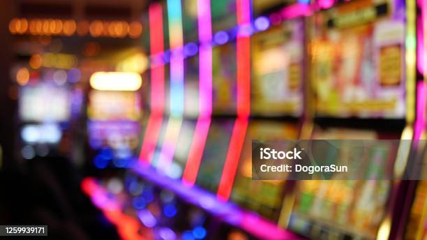 Defocused Slot Machines Glow In Casino On Fabulous Las Vegas Strip Usa Blurred Gambling Jackpot Slots In Hotel Near Fremont Street Illuminated Neon Fruit Machine For Risk Money Playing And Betting Stock Photo - Download Image Now