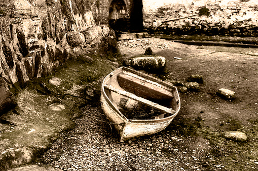 Old deserted traditional wooden fishing boat in Milos island, Cyclades, Greece