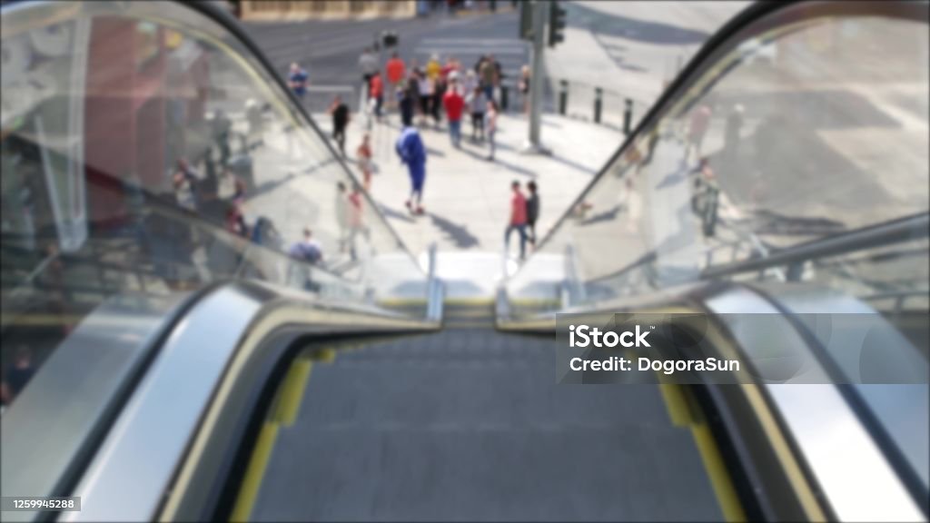 Perspective view thru escalator, defocused unrecognizable group of people on road intersection crosswalk on Strip of Las Vegas, USA. Anonymous blurred pedestrians on walkway in crowded urban downtown Perspective view thru escalator, defocused unrecognizable group of people on road intersection crosswalk on Strip of Las Vegas, USA. Anonymous blurred pedestrians on walkway in crowded urban downtown. Las Vegas Stock Photo
