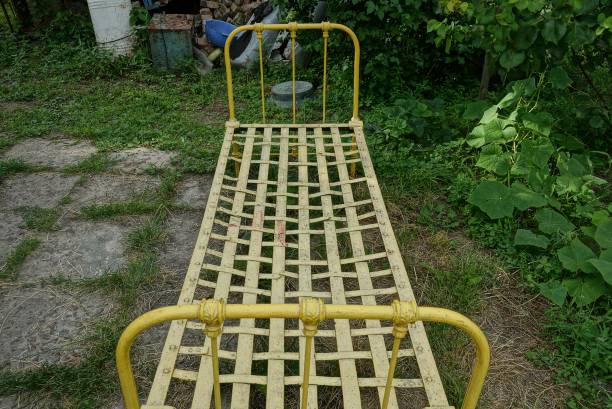 istock retro yellow iron bed stands on gray ground 1259969846
