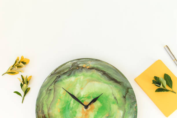 istock Clock resin art with diary, pen and branches on white background. Flat lay, top view 1259983693