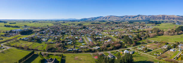 Panoramic Aerial view of Shannon in New Zealand an aerial view of Shannon in the Manawatu of New Zealand, the shot is a panorama of three stitched images taken from the south looking north over the plains with the Tararua ranges in the background manawatu stock pictures, royalty-free photos & images