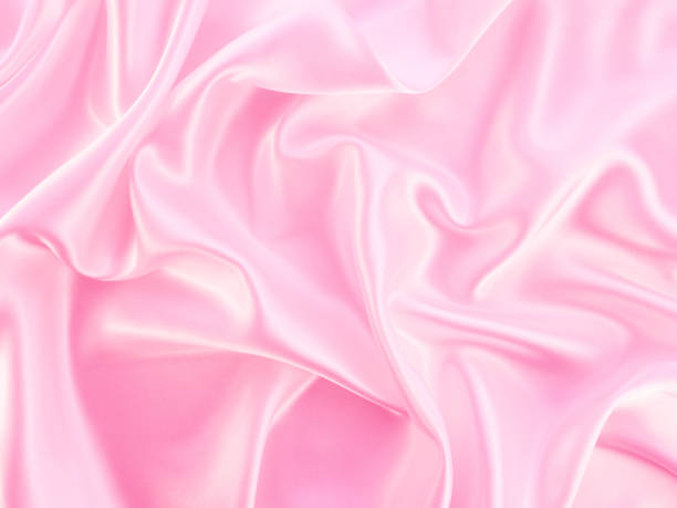 istock Beautiful elegant wavy light pink satin silk. 1259993762