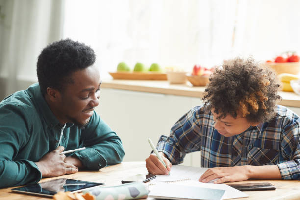 istock Father and son studying at home 1259999074