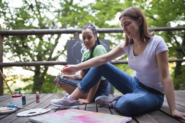 istock Two women painting in nature 1259999621