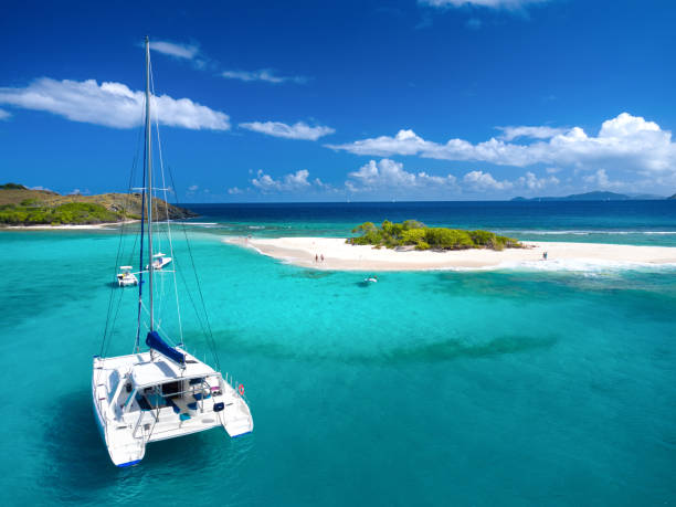 Aerial view of Catamaran at Sandy Spit, British Virgin Islands Aerial view of Catamaran at Sandy Spit, British Virgin Islands, Caribbean passenger craft photos stock pictures, royalty-free photos & images