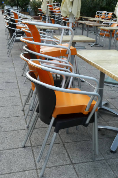 istock Stacked chairs one on another in front of restaurant outdoors 1260006012