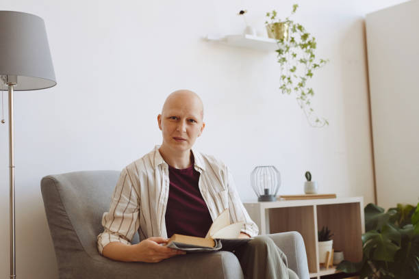 istock Modern Bald Woman Reading at Home 1260017807