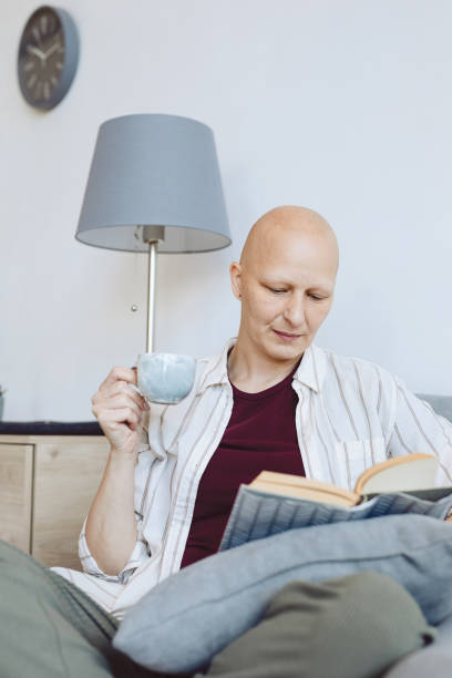 istock Bald Woman Reading at Home 1260017813