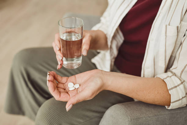 istock Woman Taking Pills Close Up 1260018379