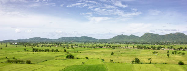istock Panorama Green field with mountain background, Thailand. 1260018416