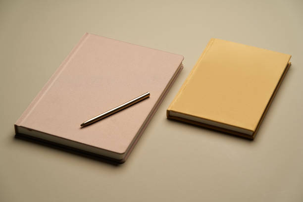 istock Notebook and golden pen, top view. Blank diary cover and pen 1260029896