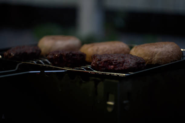 istock Juicy beef, fried on a grill with bread for the Burger. Evening dinner on the fire 1260032102