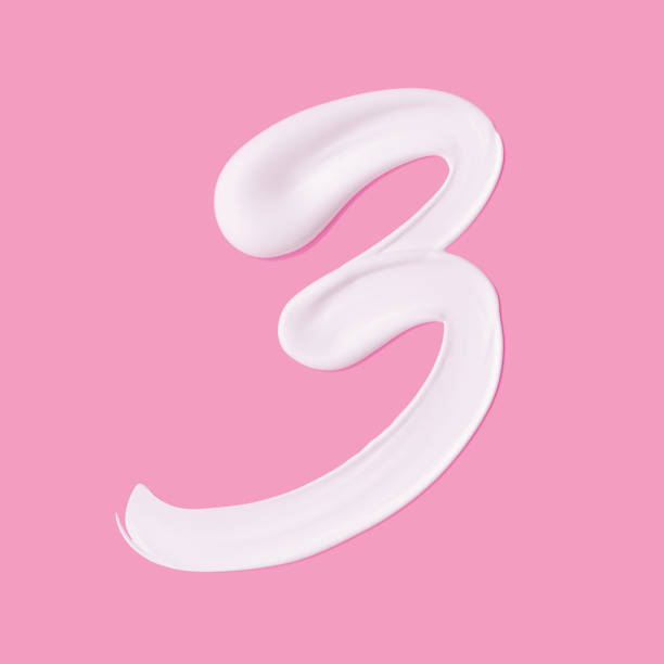 istock Numeral 3. Cosmetic white cream smeared number Three paint stroke isolated on pink background. 3d rendering 1260044602