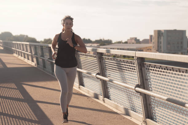 istock Young woman running at the Bridge 1260049464