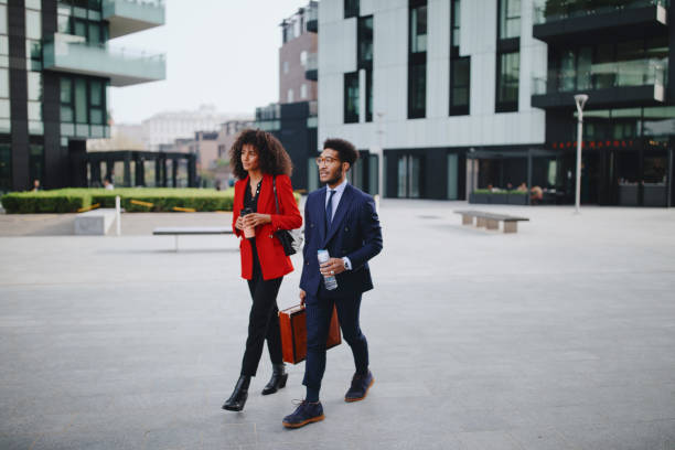 istock Two coworkers having a discussion while walking in the city 1260060396
