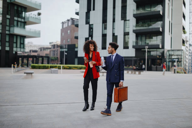 istock Two coworkers having a discussion while walking in the city 1260062135