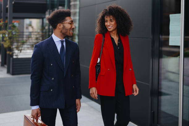 istock Two coworkers having a discussion while walking in the city 1260067752
