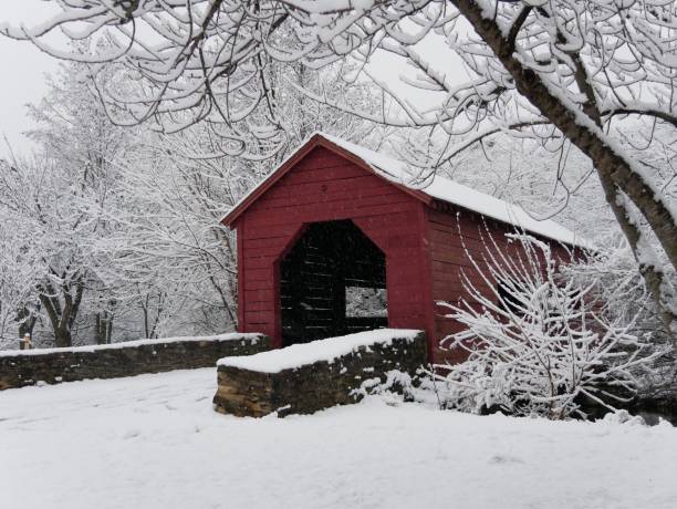 istock Snowy day at covered bridge 1260068350