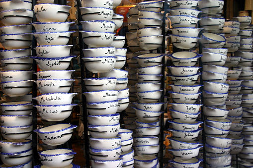 Typical bowls from Brittany, with first names inscribed on them, are stacked one on top of the other.