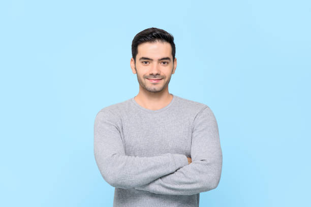 istock Smiling friendly handsome man in plain gray t-shirt with arms crossed 1260077779