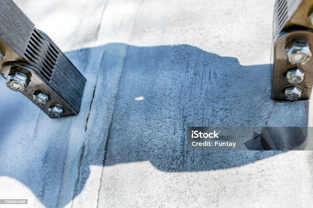 A close-up of the surface of a pipeline showing indications of stress corrosion cracking (two clusters of small black lines) revealed by MPI. Cracks that would normally have been invisible. Examining Stock Photo A close-up of the surface of a pipeline showing indications of stress corrosion cracking (two clusters of small black lines) revealed by MPI. Cracks that would normally have been invisible. Examining Stock Photo