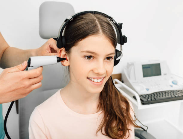 istock Audiologist is doing a hearing exam on a girl. Impedance audiometry. Methods for testing the middle ear in a child 1260085746
