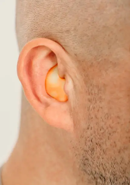 Photo of Customized orange ear plugs for noisy places. Personally molded earplugs for human ear.