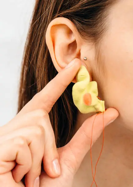 Photo of Personally molded earplugs. Process of making earplug from an impression of an individual s woman ear. Audiology. Part of the set