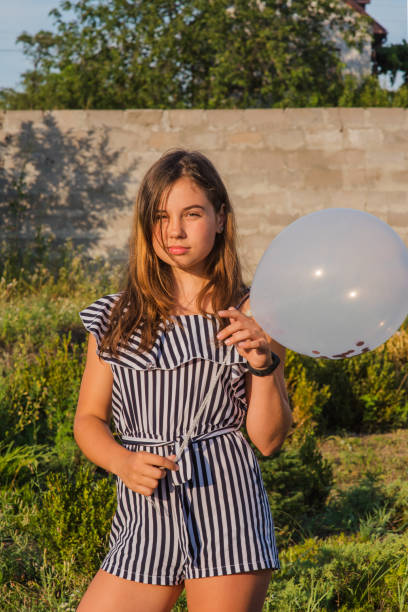 istock Young Girl Outdoors with Balloon 1260096822