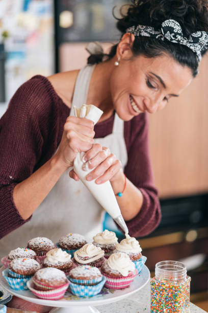 istock Confectioner decorating Chocolate Muffins 1260098464