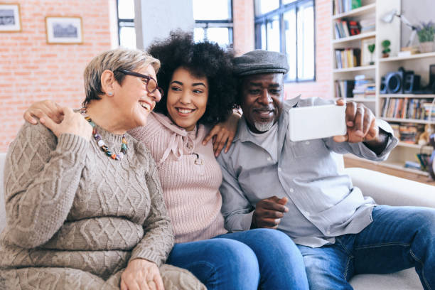 istock Multi-ethnic family having fun at home using smart phone 1260099027