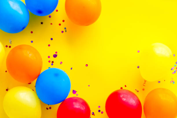 istock Party concept with colorful balloons on yellow background top view copy space 1260108644