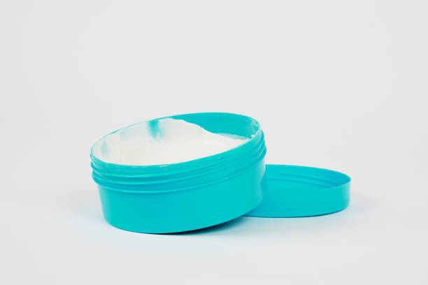 istock Blue open jar with cream on white background, side view 1260118844