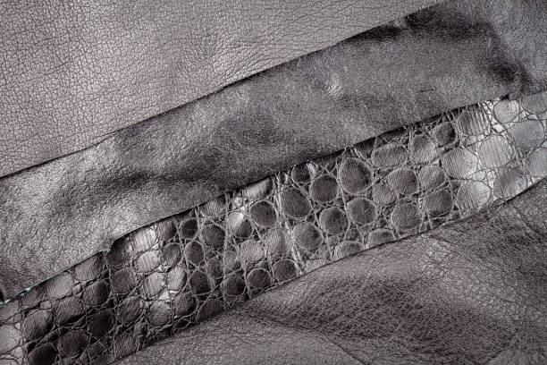 istock Black leather and fake alligator skin textures background 1260126044