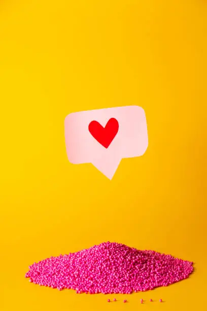 Photo of Social media promotion success concept. Pink heart-shaped emoji
