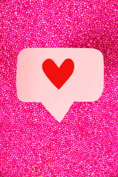 Photo of Social media promotion success concept. Pink heart-shaped emoji