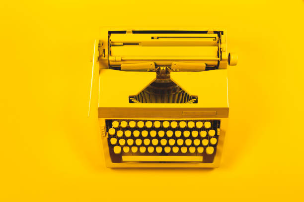 istock Yellow bright typewriter on a yellow background. Creativity concept 1260138901