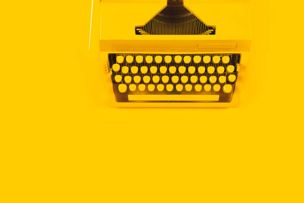 istock Yellow bright typewriter on a yellow background. Creativity concept 1260139441