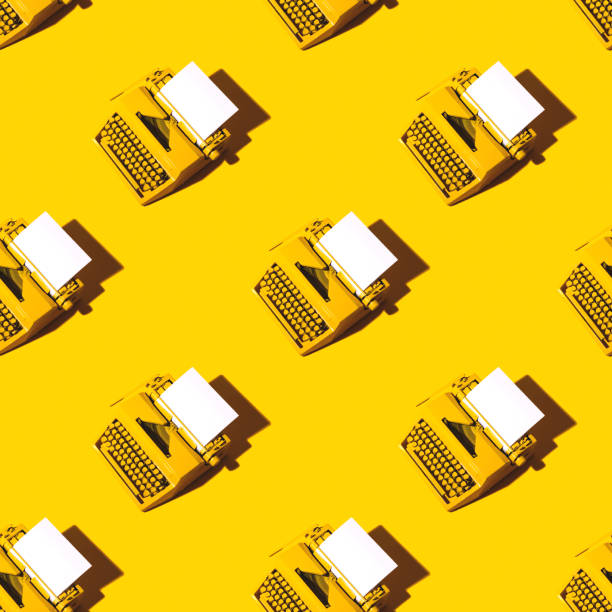 Yellow bright typewriter on a yellow background. Creativity concept