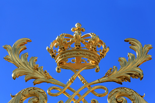 Europe. France. Ile-de-France. Yvelines. Versailles. 09/30/2017. This colorful image depicts the crown on the royal gate gilded with fine gold. The Palace of Versailles.
