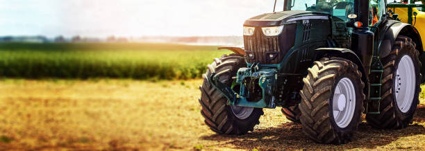 agricultural machinery farm equipment - tractor standing on the field. banner copy space agricultural machinery farm equipment - tractor standing on the field. banner copy space agricultural machinery photos stock pictures, royalty-free photos & images