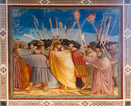 Fresco painted by Giotto. Judas kisses Jesus surrounded by the crowd.