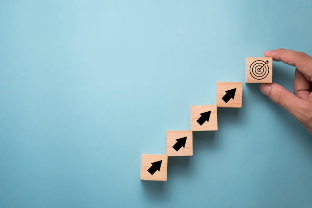 istock Hand putting virtual target board and arrow which print screen on wooden cube. Business achievement goal and objective target concept. 1260182535
