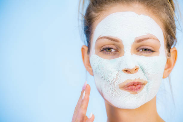 istock Girl with dry white mud mask on face 1260183114